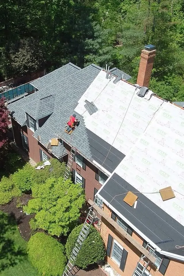 O'LYN Roofing contractor performing a roof replacement in MA